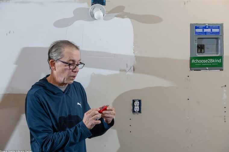 A Brightline electrician at work on a Portland home