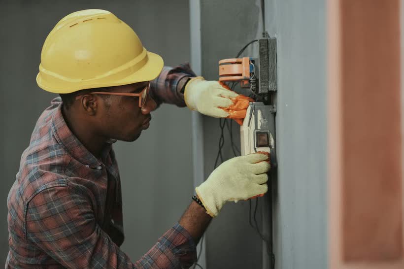 Electrician installing a clean 200A electrical panel
